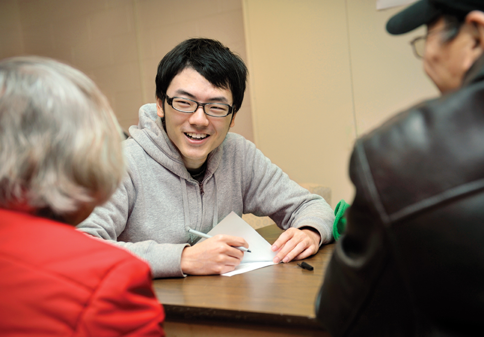Student speaks with older adults