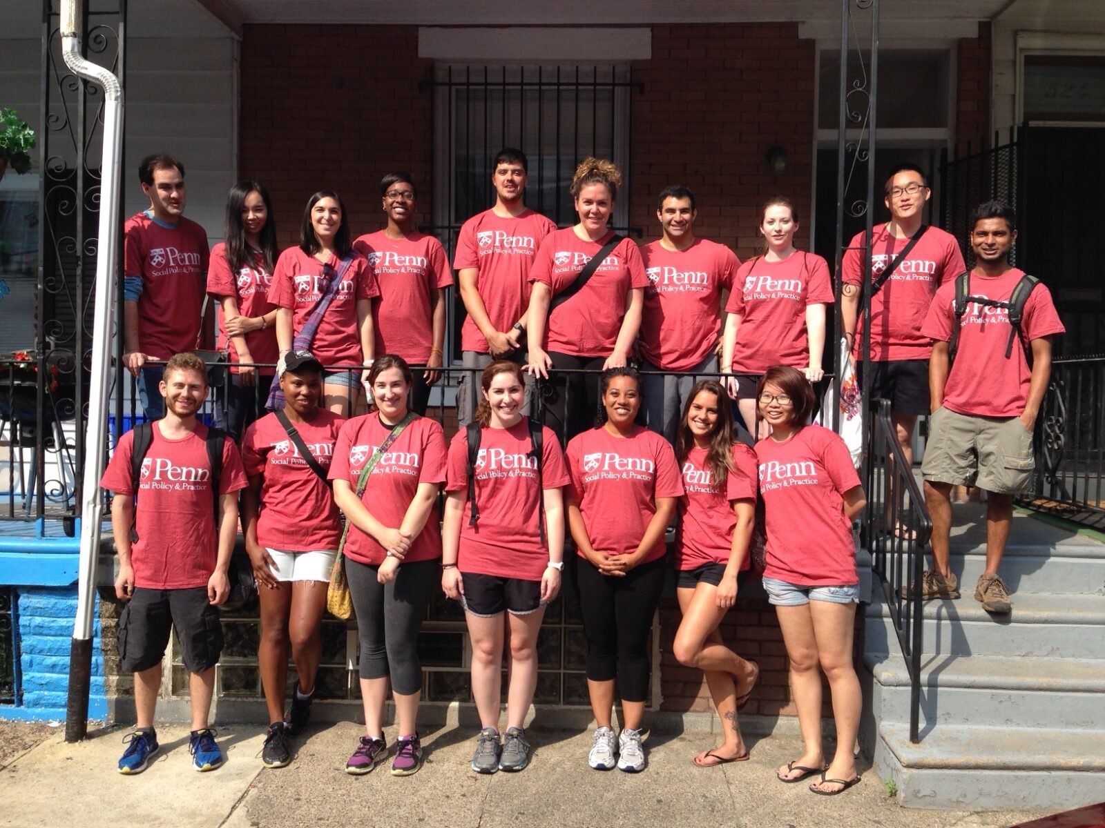 Community Teamworks volunteers gather outside of the home they painted for ACHIEVEability in West Philadelphia.