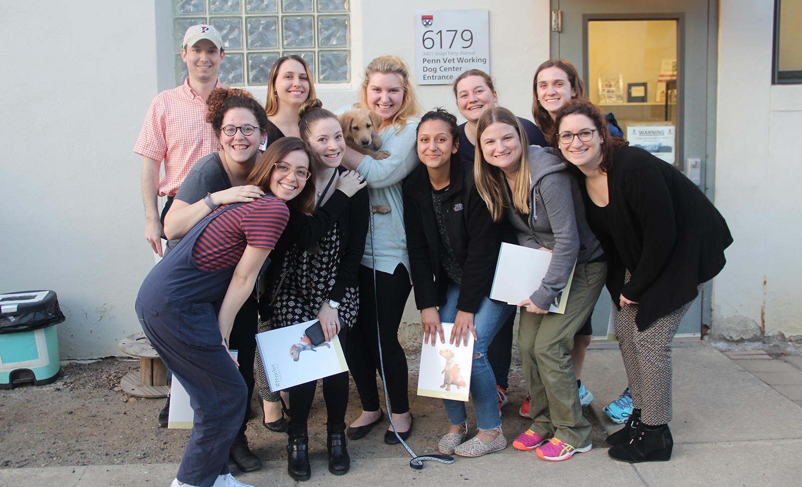 Students from SP2's Animal and Social Work course pose with a puppy.