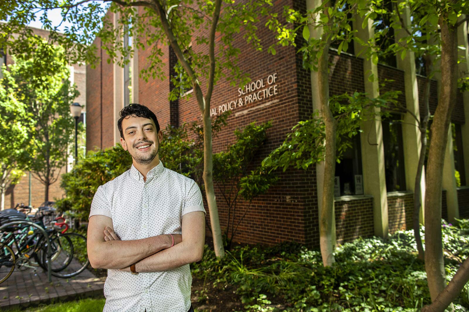 Joshua Jordan in front of the School of Social Policy & Practice