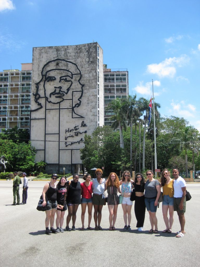 A class photo in front of an iconic hotel in Cuba