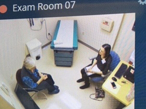 aerial view of a student and an older patient meeting in a medical office