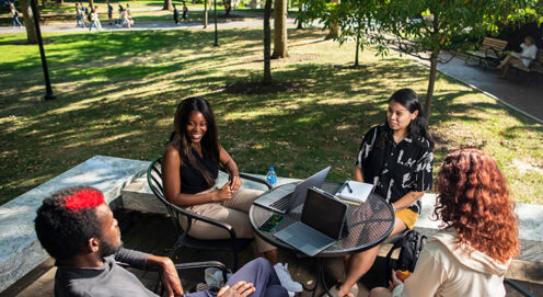 Overhead view of four students outdoors at a table on Penn's campus