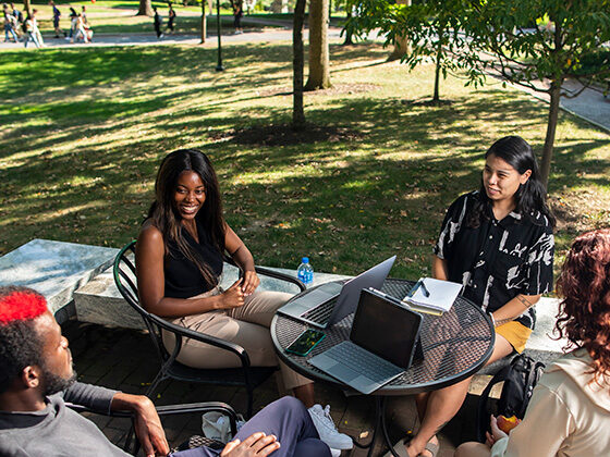 Overhead view of four students outdoors at a table on Penn's campus