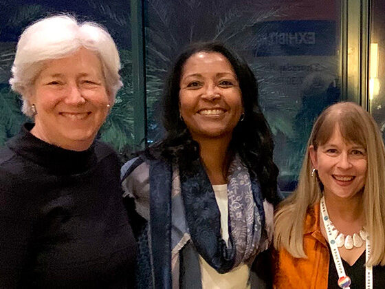 Dean Bachman and Drs. Tamara Cadet and Barbara Jones stand together smiling.