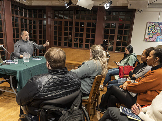 Ben Jealous and Camille Charles speak at a table before an audience