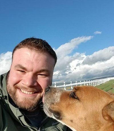 Adam Clark poses with a dog