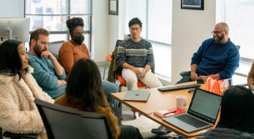 members of SAFElab meet around a table