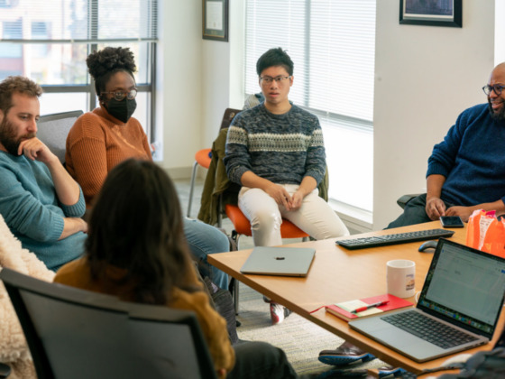 members of SAFElab meet around a table