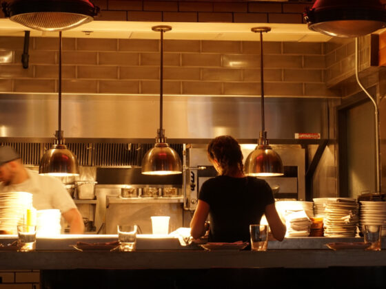 Restaurant worker retrieves food from a counter