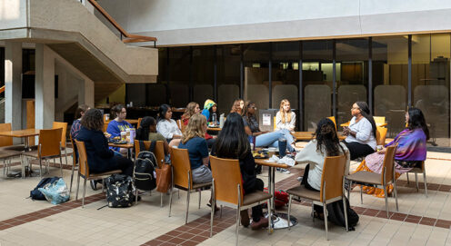 MSW students sit in a circle of chairs in the McNeil Building atrium