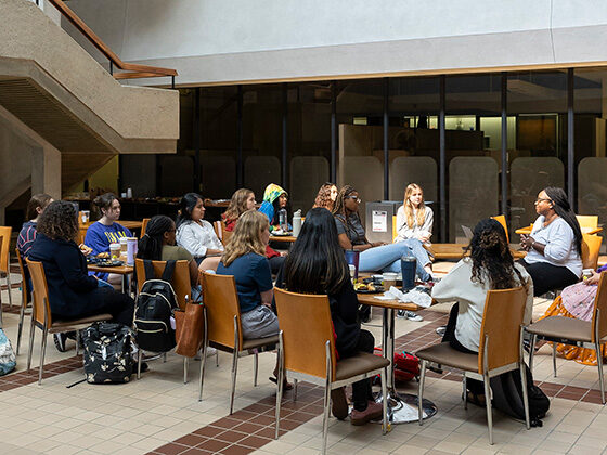 MSW students sit in a circle of chairs in the McNeil Building atrium