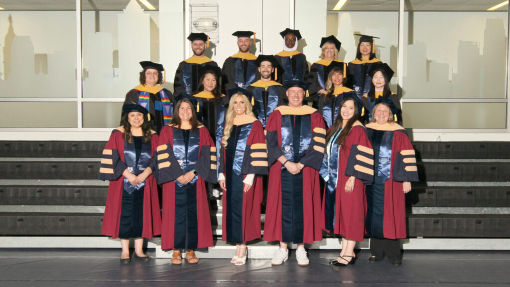 DSW graduates stand in regalia at 2025 commencement.