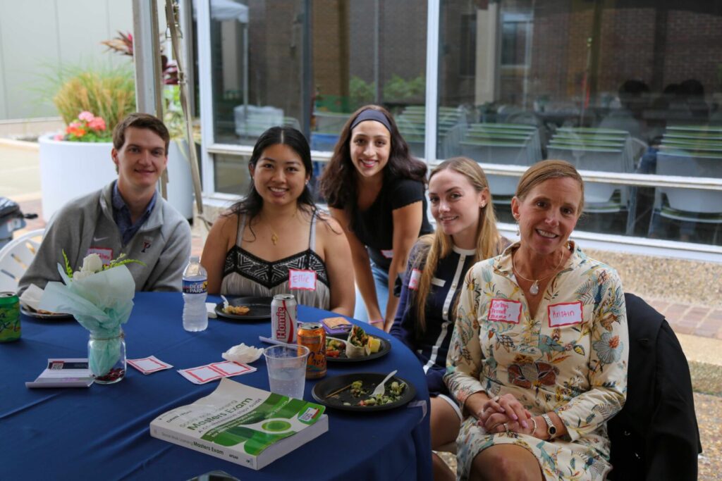 Five people sit at a table at SP2's Celebrating Partnerships and Student Impact event