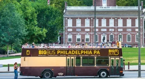 Photograph of a Brown bus in front of a colonial building in Old City Philadelphia