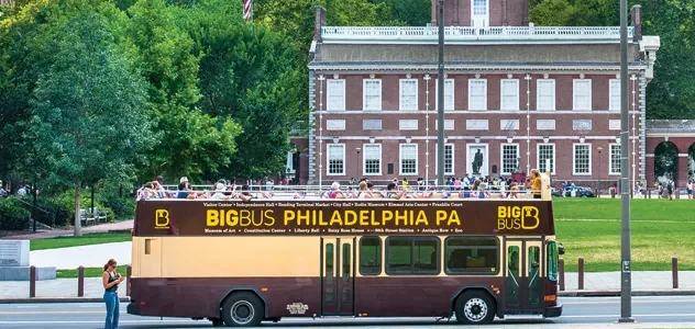 Photograph of a Brown bus in front of a colonial building in Old City Philadelphia