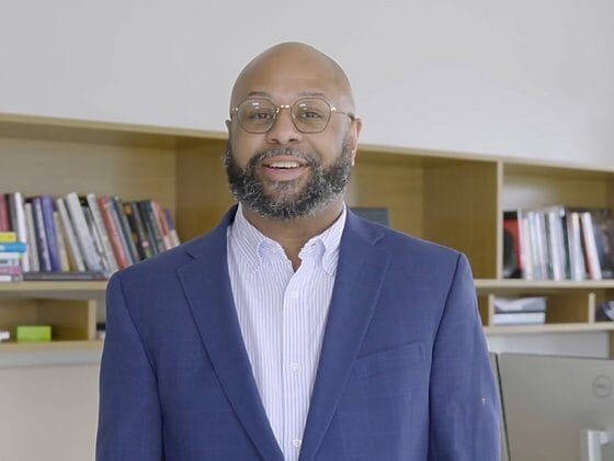 Desmond Patton in his office, discussing AI interventions to combat youth violence