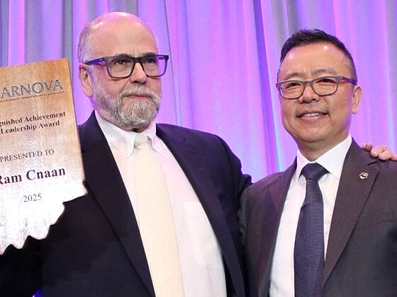 Ram Cnaan and Chao Guo on stage at the ARNOVA conference awards ceremony